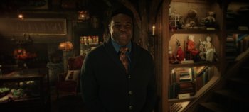 Movie still from “Hocus Pocus 2” (2022), directed by Anne Fletcher – A man wearing a sweater and a neck tie; Medium shot, Over the shoulder angle