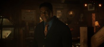 Movie still from “Hocus Pocus 2” (2022), directed by Anne Fletcher – A man wearing a suit and tie in a dark room; Close Up shot, Over the shoulder angle