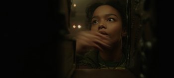 Movie still from “Hocus Pocus 2” (2022), directed by Anne Fletcher – A young woman looking into a mirror with her hand on her face; Close Up shot, Low angle