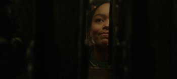 Movie still from “Hocus Pocus 2” (2022), directed by Anne Fletcher – A young woman looking out a window at night; Close Up shot, Low angle