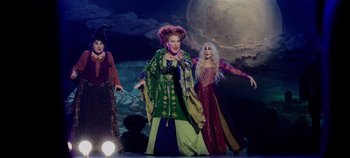 Movie still from “Hocus Pocus 2” (2022), directed by Anne Fletcher – A group of women dressed in costumes on a stage; Wide shot, High angle
