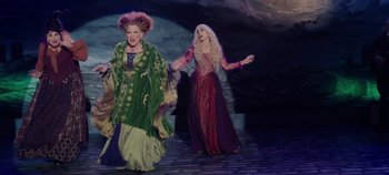 Movie still from “Hocus Pocus 2” (2022), directed by Anne Fletcher – Two women dressed in costumes on a stage; Wide shot, High angle
