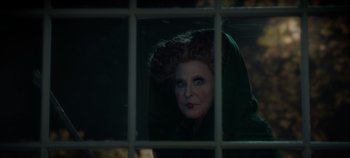 Movie still from “Hocus Pocus 2” (2022), directed by Anne Fletcher – A woman looking out of a window at night; Close Up shot, Over the shoulder angle