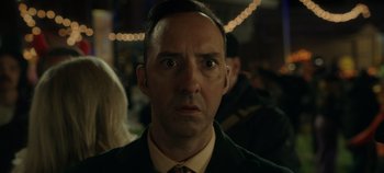 Movie still from “Hocus Pocus 2” (2022), directed by Anne Fletcher – A person wearing a suit and tie; Close Up shot, Low angle