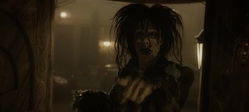 Movie still from “Hocus Pocus 2” (2022), directed by Anne Fletcher – A person with a face paint and long black hair; Close Up shot, Over the shoulder angle