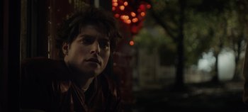Movie still from “Hocus Pocus 2” (2022), directed by Anne Fletcher – A young man is sitting in the dark outside; Close Up shot, Low angle