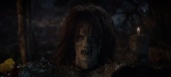 Movie still from “Hocus Pocus 2” (2022), directed by Anne Fletcher – A person with a face paint and a long hair; Close Up shot, Over the shoulder angle