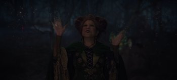 Movie still from “Hocus Pocus 2” (2022), directed by Anne Fletcher – An image of a woman in a costume in the dark; Medium shot, Low angle