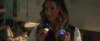 Movie still from “Holiday Harmony” (2022), directed by Shaun Paul Piccinino – A woman is holding a glowing object in her hands; Close Up shot, Over the shoulder angle