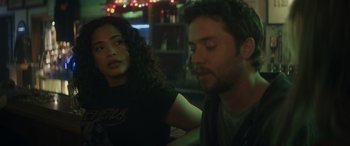 Movie still from “Holiday Harmony” (2022), directed by Shaun Paul Piccinino – A man and a woman sitting at a table in a restaurant; Close Up shot, Over the shoulder angle