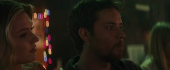 Movie still from “Holiday Harmony” (2022), directed by Shaun Paul Piccinino – A person looking at something; Close Up shot, Over the shoulder angle