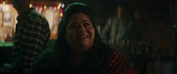 Movie still from “Holiday Harmony” (2022), directed by Shaun Paul Piccinino – A person smiling at the camera; Close Up shot, Over the shoulder angle