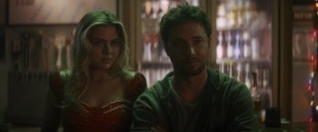 Movie still from “Holiday Harmony” (2022), directed by Shaun Paul Piccinino – A man and a woman standing next to each other; Close Up shot, Over the shoulder angle