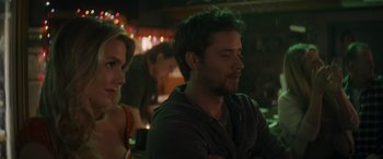 Movie still from “Holiday Harmony” (2022), directed by Shaun Paul Piccinino – A man and a woman sitting at a table; Close Up shot, Over the shoulder angle
