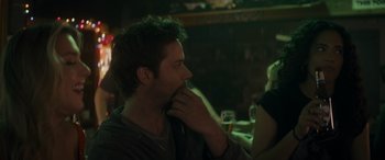 Movie still from “Holiday Harmony” (2022), directed by Shaun Paul Piccinino – A man sitting at a table in front of a woman; Close Up shot, Over the shoulder angle