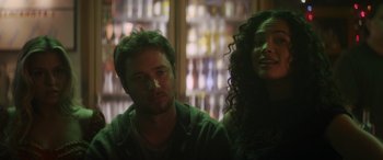 Movie still from “Holiday Harmony” (2022), directed by Shaun Paul Piccinino – A man and a woman sitting next to each other in a bar; Close Up shot, Low angle