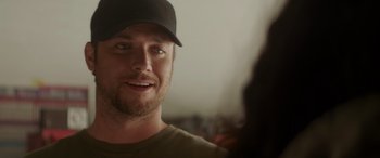 Movie still from “Holiday Harmony” (2022), directed by Shaun Paul Piccinino – A person wearing a hat; Close Up shot, Over the shoulder angle