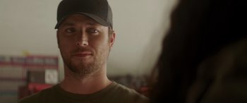 Movie still from “Holiday Harmony” (2022), directed by Shaun Paul Piccinino – A person wearing a hat; Close Up shot, Over the shoulder angle