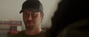 Movie still from “Holiday Harmony” (2022), directed by Shaun Paul Piccinino – A person wearing a hat; Close Up shot, Over the shoulder angle