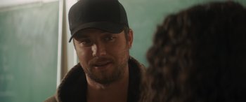 Movie still from “Holiday Harmony” (2022), directed by Shaun Paul Piccinino – A person wearing a hat; Close Up shot, Over the shoulder angle