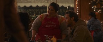 Movie still from “Holiday Harmony” (2022), directed by Shaun Paul Piccinino – Two people sitting at a table in a restaurant; Medium shot, Over the shoulder angle