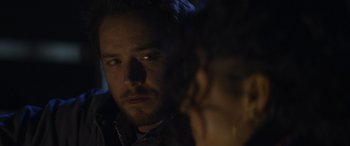 Movie still from “Holiday Harmony” (2022), directed by Shaun Paul Piccinino – A person looking at the camera; Close Up shot, Over the shoulder angle