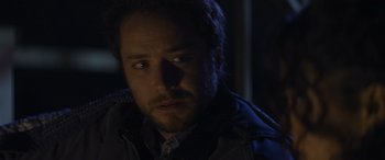 Movie still from “Holiday Harmony” (2022), directed by Shaun Paul Piccinino – A person wearing a jacket; Close Up shot, Over the shoulder angle