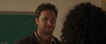 Movie still from “Holiday Harmony” (2022), directed by Shaun Paul Piccinino – A person looking at a mirror; Close Up shot, Over the shoulder angle