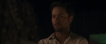 Movie still from “Holiday Harmony” (2022), directed by Shaun Paul Piccinino – A person wearing a shirt; Close Up shot, Over the shoulder angle