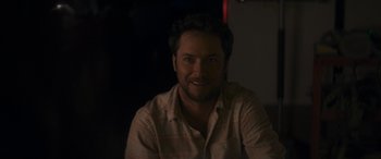 Movie still from “Holiday Harmony” (2022), directed by Shaun Paul Piccinino – A person smiling for the camera; Close Up shot, Over the shoulder angle