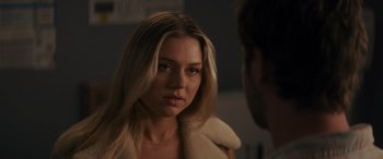 Movie still from “Holiday Harmony” (2022), directed by Shaun Paul Piccinino – A woman with long blonde hair wearing a white jacket; Close Up shot, Over the shoulder angle