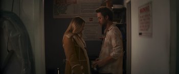 Movie still from “Holiday Harmony” (2022), directed by Shaun Paul Piccinino – A man and a woman standing next to each other; Medium shot, Over the shoulder angle