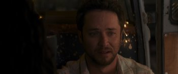 Movie still from “Holiday Harmony” (2022), directed by Shaun Paul Piccinino – A person looking at the camera; Close Up shot, Over the shoulder angle