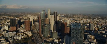 Movie still from “Holiday Harmony” (2022), directed by Shaun Paul Piccinino – An aerial view of a city with skyscrapers; Extreme Wide shot, High angle