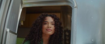 Movie still from “Holiday Harmony” (2022), directed by Shaun Paul Piccinino – A person with curly hair; Close Up shot, Low angle