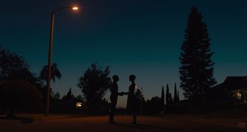 Movie still from “Hollywood Stargirl” (2022), directed by Julia Hart – Two people standing under a streetlight at night; Extreme Wide shot, Low angle