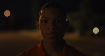 Movie still from “Hollywood Stargirl” (2022), directed by Julia Hart – A young man is looking into the camera; Close Up shot, Low angle