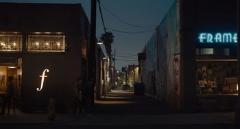 Movie still from “Hollywood Stargirl” (2022), directed by Julia Hart – Two people standing on the side of a street at night; Extreme Wide shot, Low angle