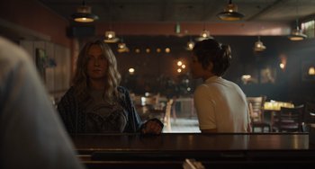 Movie still from “Hollywood Stargirl” (2022), directed by Julia Hart – Two women are sitting at a bar talking to each other; Medium shot, Over the shoulder angle