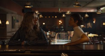 Movie still from “Hollywood Stargirl” (2022), directed by Julia Hart – Two people sitting at a table in front of each other; Medium shot, Over the shoulder angle