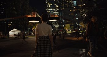 Movie still from “Hollywood Stargirl” (2022), directed by Julia Hart – A woman standing in the middle of the street at night; Extreme Wide shot, Over the shoulder angle