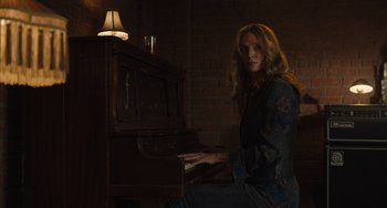 Movie still from “Hollywood Stargirl” (2022), directed by Julia Hart – A woman sitting in front of an upright piano; Medium shot, Low angle