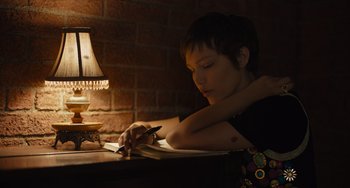 Movie still from “Hollywood Stargirl” (2022), directed by Julia Hart – A person sitting at a table writing in a notebook; Medium shot, High angle