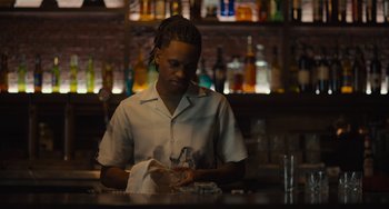 Movie still from “Hollywood Stargirl” (2022), directed by Julia Hart – A person sitting at a bar with a napkin in front of him; Medium shot, Low angle