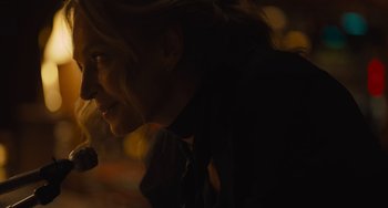 Movie still from “Hollywood Stargirl” (2022), directed by Julia Hart – A woman is smiling at the camera in the dark; Close Up shot, Over the shoulder angle