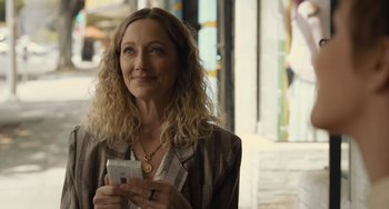 Movie still from “Hollywood Stargirl” (2022), directed by Julia Hart – A woman holding a cell phone in her hands; Close Up shot, Over the shoulder angle