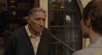 Movie still from “Hollywood Stargirl” (2022), directed by Julia Hart – An older man is looking at something in the distance; Close Up shot, Over the shoulder angle