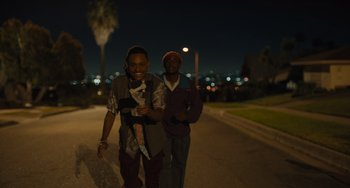 Movie still from “Hollywood Stargirl” (2022), directed by Julia Hart – Two young men walking down a street at night; Medium shot, Low angle