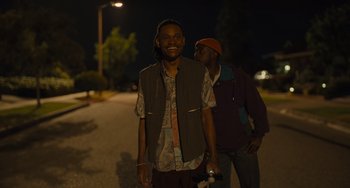 Movie still from “Hollywood Stargirl” (2022), directed by Julia Hart – Two men walking down a street at night; Medium shot, Low angle