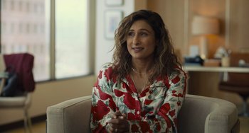 Movie still from “Hollywood Stargirl” (2022), directed by Julia Hart – A woman sitting on a couch wearing a red floral shirt; Medium shot, Over the shoulder angle